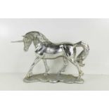 A silvered plaster figure of a unicorn.