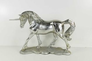 A silvered plaster figure of a unicorn.