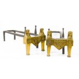 A pair of Egyptian revival brass and iron andirons, each having two face masks above rosettes,
