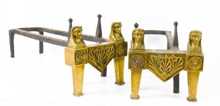 A pair of Egyptian revival brass and iron andirons, each having two face masks above rosettes,