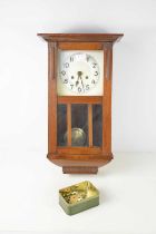 An oak cased wall clock, silvered dial, with key and pendulum. [This lot has been kindly donated for