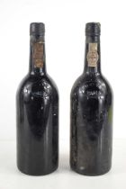 Two bottles of Dow's 1972 Vintage Port, caps and seals present, one with signs of seepage, labels