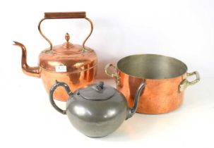 A group of metal wares comprising a large two handled copper pan, a copper kettle and a Victorian