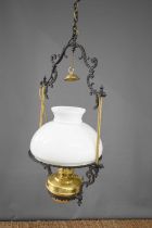 A pair of oil lamp style ceiling lights with glass chimneys and white shades. [This lot has been