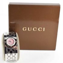 A Gucci stainless steel Quartz twirl watch, with original booklet.