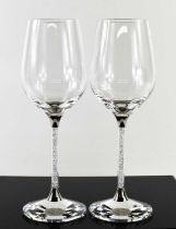 A pair of Swarovski crystal wine glasses, the clear crystal fills the stems and the faceted clear