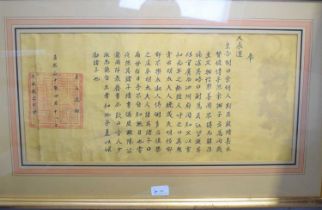 A Chinese framed and glazed yellow silk hanging with character mark and script. [This lot has been