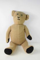 A large vintage teddy bear, with wool body, button eyes, embroidered nose and mouth and velvet paws,