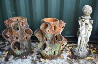 Two large antique terracotta strawberry planters of tree trunk design together with a stone base for