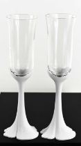 A pair of Oscar de La Renta Champagne flutes, with white perspex stems stamped '200 ans', the