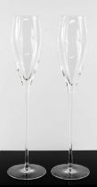 A pair of crystal Millennium champagne flutes, with long tapered stems, 33cm high.