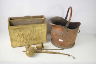 A copper helmet coal scuttle, three brass and copper spirit ladles, named whisky, rum and brandy,