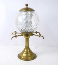 A 1920s brass and glass absinthe fountain, and spherical patterned glass bowl raised on the brass