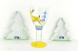 A Swedish Bergdala goblet, hand painted with a reindeer and a Christmas tree, in signature yellow