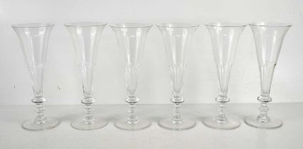 A set of six crystal glass champagne flutes by William Yeoward, 21cm high.