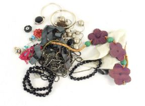 A group of silver and costume jewellery including a silver bangle, a silver bracelet set with