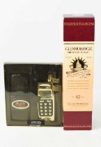 A bottle of Glenmorangie Millenium Malt Whisky, boxed, together with a hipflask modelled as a mobile