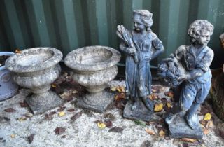 Two reconstituted stone garden statues of a young boy holding a basket of flowers and a girl holding