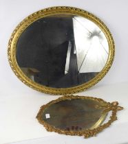 Two oval gilt coloured wall mirrors, the largest 78 by 64cm. [This lot has been kindly donated for