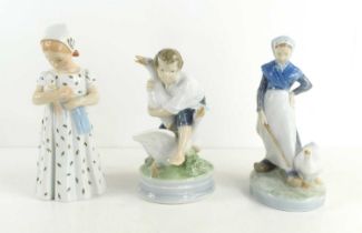 A group of three Royal Copenhagen figurines to include a young girl holding a doll, number 561, a