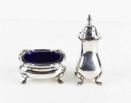 A silver salt with blue glass liner, raised on four feet, together with a silver salt pot with