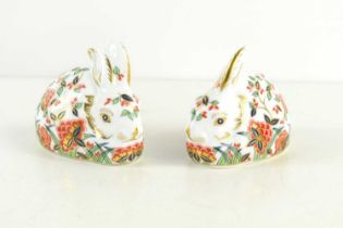 A pair of Royal Crown Derby Meadow Rabbit paperweights, one with a silver stopper the other with a