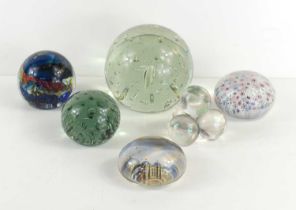 A group of glass paperweights to include millefiori, tear drop and other examples.