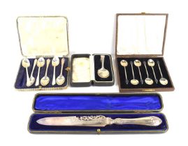 A group of silver comprising of a cased set of six of silver teaspoons, a cased set of six coffee