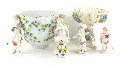 A group of cherub figurines to include example by Meissen together with a 19th century floral basket