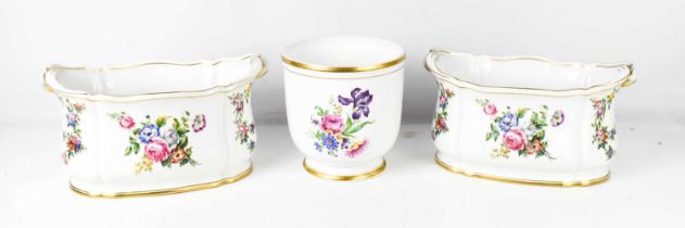 A set of Portuguese porcelain jardinieres, all painted with floral groups, and including a pair of