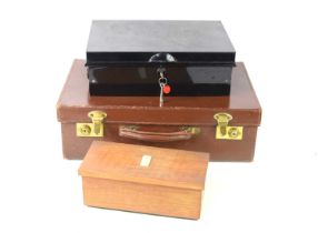 A vintage leather case together with a metal lock box and a wooden musical jewellery box.