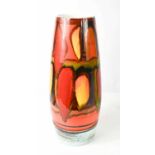 A large Poole Pottery sleeve vase with red orange and green abstract design and a blue border to the