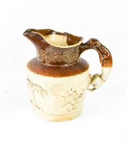 A Victorian stoneware jug, modelled with greyhound form handle, and the body relief moulded with