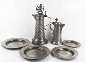 Two pewter jugs, circa 1880, one with cover bearing lion sejant finial and wrythern body 38cm
