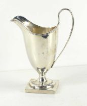 A helmet shaped cream jug by George Nathan & Ridley Hayes, Chester 1901, with a reeded border and on