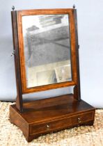 A Georgian mahogany toilet mirror, fitted with a single drawer with two gilt brass hoop handles,