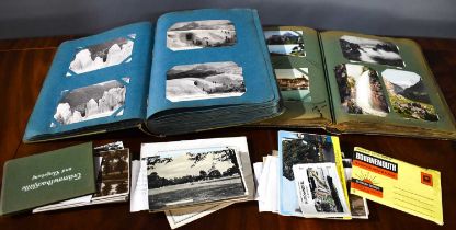 A group of postcards, to include two albums, in colour and black and white, scenes of France and