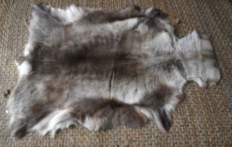 A reindeer hide rug / throw, 86cm by 132cm.