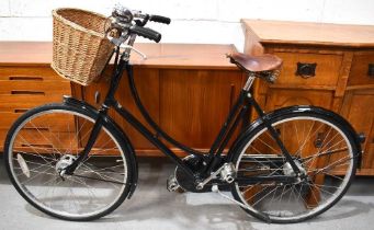 A lady's Pashley bicycle with basket and bell.