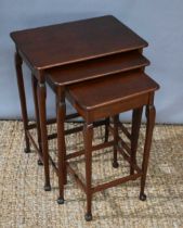 A nest of three mahogany tea tables, the shaped legs raised on pad feet, 56cm high.