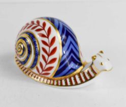 A Royal Crown Derby paperweight in the form of a snail, with silver stopper, 13cm long.