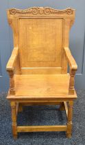 An Arts and Crafts style oak hall chair with carved mouse to the top rail, in the manner of Robert