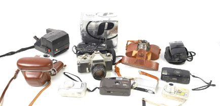 A group of vintage cameras to include Kodak, Polaroid 635CL, Cannon, Olympus, Polaroid Plus,