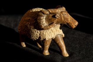 A contemporary stone sculpture of an American Bighorn Sheep in the round with smoothly carved