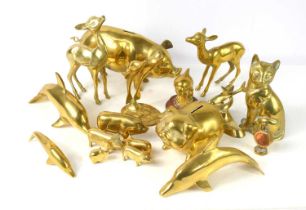 A large collection of brass animals including, dolphins, deer, pigs and a cat.