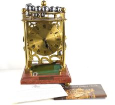 A Harding & Bazeley limited edition spherical weight clock. number 534 of 1000 the brass frame