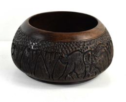An African turned hardwood bowl, with carved animal decoration, 10cm high.