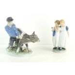 Two Royal Copenhagen figure groups comprising of a young boy with calf number 772, 17cm high and two