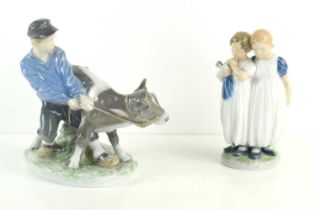 Two Royal Copenhagen figure groups comprising of a young boy with calf number 772, 17cm high and two