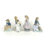 A group of four Lladro Nao porcelain figurines to include a young girl with doves, 15cm high, a